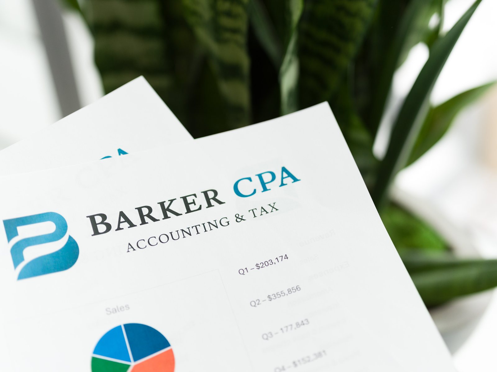 Barker CPA financial statements on a desk